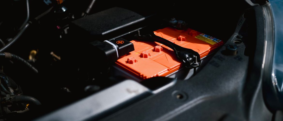 Detailed view of an electric car battery inside a vehicle's engine compartment, highlighting sustainable technology.